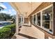 Brick front porch with white columns, ceiling fans, and tile flooring at 2409 Royal Oak Circle, North Myrtle Beach, SC 29582