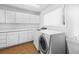 Laundry room with washer, dryer, and white cabinets at 2409 Royal Oak Circle, North Myrtle Beach, SC 29582