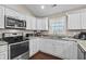 Modern kitchen with stainless steel appliances and white cabinets at 2579 Allen Dew Rd., Conway, SC 29527