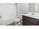 Clean bathroom with white tub/shower combo, dark brown vanity, and gray floor at 293 Foxpath Loop, Myrtle Beach, SC 29588