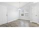 Bright dining area with gray walls, wood-look floors, and ample natural light at 293 Foxpath Loop, Myrtle Beach, SC 29588