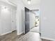 Light and airy entryway with gray walls, wood-look floors, and black front door at 293 Foxpath Loop, Myrtle Beach, SC 29588