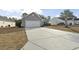 Gray house with a two-car garage and a palm tree in the front yard at 293 Foxpath Loop, Myrtle Beach, SC 29588