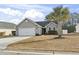 Gray house with a two-car garage and a palm tree in the front yard at 293 Foxpath Loop, Myrtle Beach, SC 29588