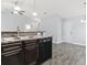 Modern kitchen with dark brown cabinets and black appliances at 293 Foxpath Loop, Myrtle Beach, SC 29588