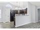 Open kitchen with breakfast bar, dark brown cabinets, and black appliances at 293 Foxpath Loop, Myrtle Beach, SC 29588