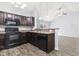 Kitchen with dark brown cabinets, black appliances, and granite countertop at 293 Foxpath Loop, Myrtle Beach, SC 29588