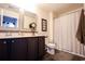 Clean bathroom with dark brown vanity, shower, and white toilet at 2998 Skylar Dr., Myrtle Beach, SC 29577