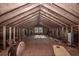 Unfinished attic space with wood framing and window at 300 Mcarthur St., Tabor City, NC 28463