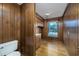 Small bathroom with wood-paneled walls and hardwood floor at 300 Mcarthur St., Tabor City, NC 28463