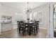 Bright dining room features a large table with seating for eight and a stunning chandelier at 308 Turning Pines Loop, Myrtle Beach, SC 29579