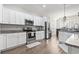 Modern kitchen with white cabinets and stainless steel appliances at 308 Turning Pines Loop, Myrtle Beach, SC 29579