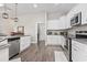 Modern kitchen with white cabinets, granite countertops, and stainless steel appliances at 308 Turning Pines Loop, Myrtle Beach, SC 29579