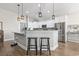 Kitchen island with seating, granite countertops and modern pendant lighting at 308 Turning Pines Loop, Myrtle Beach, SC 29579