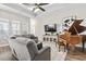 Relaxing living room features sectional sofa, large TV, and hardwood floors at 308 Turning Pines Loop, Myrtle Beach, SC 29579