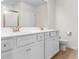 Double vanity bathroom with white cabinets and gold fixtures at 3304 Candytuft Dr., Conway, SC 29526