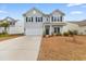 Two-story house with gray siding, a white garage door, and landscaping at 3304 Candytuft Dr., Conway, SC 29526