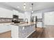 Modern kitchen with white cabinets, stainless steel appliances, and a large island at 3304 Candytuft Dr., Conway, SC 29526