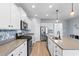 Modern kitchen with white cabinets, stainless steel appliances, and a large island at 3304 Candytuft Dr., Conway, SC 29526