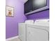 Bright laundry room with washer, dryer, and overhead cabinets at 3304 Candytuft Dr., Conway, SC 29526