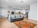 Open living room featuring a gray sofa, orange rug, and view into the kitchen at 3304 Candytuft Dr., Conway, SC 29526