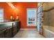 Bathroom with tiled shower, granite vanity, and orange walls at 3714 Old Pointe Circle, North Myrtle Beach, SC 29582