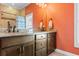 Double vanity bathroom with granite countertop and orange walls at 3714 Old Pointe Circle, North Myrtle Beach, SC 29582