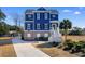 Two-story blue house with brick base, white trim, and a walkway at 3714 Old Pointe Circle, North Myrtle Beach, SC 29582