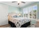 Bedroom with a wicker bed frame, patterned bedding, and window shutters at 403 36Th Ave. N, North Myrtle Beach, SC 29582