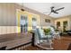 Porch with rocking chairs, yellow doors, and ceiling fan at 403 36Th Ave. N, North Myrtle Beach, SC 29582