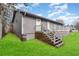 Gray house with deck and stairs leading to backyard at 4306 Princeton Dr., Little River, SC 29566