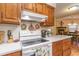 Clean kitchen with white appliances and wood cabinets at 4306 Princeton Dr., Little River, SC 29566