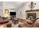 Bright living room with a stone fireplace and hardwood floors at 4306 Princeton Dr., Little River, SC 29566