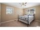 Well-lit bedroom with a metal bed frame and carpeted floors at 4637 Dogwood St., Loris, SC 29569