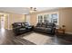 Living room with dark leather recliners and wood floors at 4637 Dogwood St., Loris, SC 29569