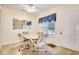 Bright dining area with table and four chairs, featuring a window and access to other rooms at 4660 Lightkeepers Way # 37A, Little River, SC 29566