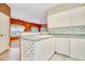 Kitchen features white cabinets, green countertops, and a view into adjacent living area at 4660 Lightkeepers Way # 37A, Little River, SC 29566