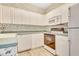 White kitchen with green countertops, featuring a dishwasher and built-in microwave at 4660 Lightkeepers Way # 37A, Little River, SC 29566