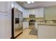 Stainless steel appliances and white cabinets in this galley kitchen at 4910 N Market St. # M9-R2, North Myrtle Beach, SC 29582