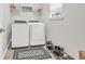 Convenient laundry room with washer, dryer, and overhead shelving at 520 Shellbark Dr., Longs, SC 29568