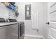 Bright laundry room with washer, dryer, and shelving at 5353 Knobcone Loop # C-103, Myrtle Beach, SC 29577