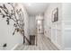 Elegant staircase with wood railing, wall art, and light-filled hallway at 5353 Knobcone Loop # C-103, Myrtle Beach, SC 29577