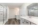 Bathroom featuring a glass shower, double sink vanity with a large mirror and wood-look flooring at 558 Haven View Way, Murrells Inlet, SC 29576