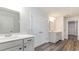 Bathroom featuring a double sink vanity with a large mirror, and a large closet at 558 Haven View Way, Murrells Inlet, SC 29576