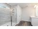 Bathroom featuring a glass shower with tiled walls, a vanity, and wood-look flooring at 558 Haven View Way, Murrells Inlet, SC 29576