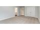 Bedroom featuring neutral walls, carpet floors, and a closet and bathroom entrance at 558 Haven View Way, Murrells Inlet, SC 29576