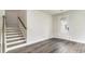 Inviting entryway with wood-look flooring, staircase, white trim, and natural light from the front door at 558 Haven View Way, Murrells Inlet, SC 29576