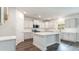 Modern kitchen with white cabinets, quartz countertops, stainless steel appliances, and a center island at 558 Haven View Way, Murrells Inlet, SC 29576