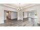 Expansive living room with wood floors, light walls, with views into the dining room, entryway, and staircase at 558 Haven View Way, Murrells Inlet, SC 29576