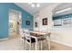 Dining area with wooden table and four chairs, view of bathroom at 5750 Oyster Catcher Dr. # 932, North Myrtle Beach, SC 29582